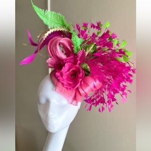 Pink and green fascinator.  Lots of detail with silk bow,leaves,feathers, flower